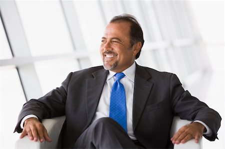 Businessman sitting in chair in office lobby Stock Photo - Budget Royalty-Free & Subscription, Code: 400-04037318