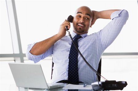 simsearch:400-05900712,k - Businessman taking call in office Stock Photo - Budget Royalty-Free & Subscription, Code: 400-04037345