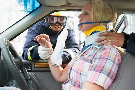 fireman driver pictures - Firefighters helping an injured woman in a car Stock Photo - Budget Royalty-Free & Subscription, Code: 400-04037768