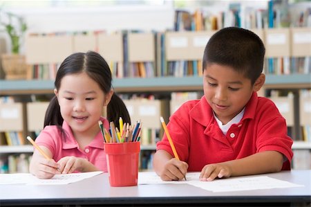 Kindergarten children sitting at desk and writing in classroom Stock Photo - Budget Royalty-Free & Subscription, Code: 400-04037827