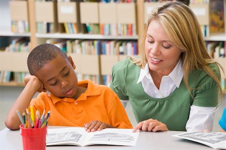 Kindergarten teacher helping student with reading skills Stock Photo - Budget Royalty-Free & Subscription, Code: 400-04037839