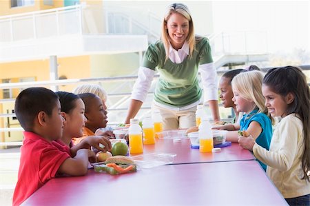 simsearch:400-04036581,k - Kindergarten teacher supervising children eating lunch Stock Photo - Budget Royalty-Free & Subscription, Code: 400-04037885