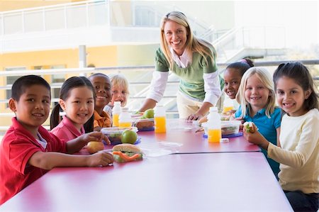 simsearch:400-04036581,k - Kindergarten teacher supervising children eating lunch Stock Photo - Budget Royalty-Free & Subscription, Code: 400-04037886