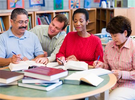 Teacher helping mature students in library Stock Photo - Budget Royalty-Free & Subscription, Code: 400-04037919
