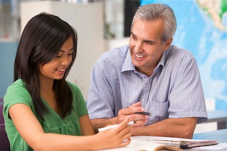 A teacher instructs a schoolgirl in a high school class Stock Photo - Budget Royalty-Free & Subscription, Code: 400-04037996