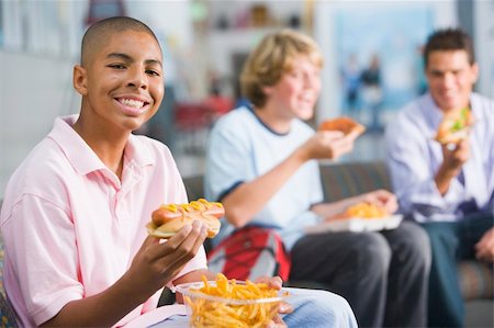 simsearch:400-04036581,k - Teenage boys enjoying fast food lunches together Stock Photo - Budget Royalty-Free & Subscription, Code: 400-04038026