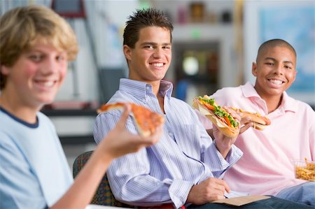 simsearch:400-04036581,k - Teenage boys enjoying fast food lunches together Stock Photo - Budget Royalty-Free & Subscription, Code: 400-04038029