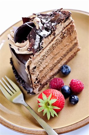 decorating a chocolate frosted cake - Slice of chocolate mousse cake served on a plate Stock Photo - Budget Royalty-Free & Subscription, Code: 400-04038099