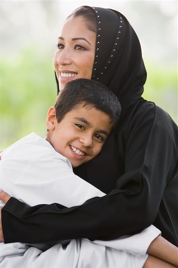 A Middle Eastern woman and her son sitting in a park Stock Photo - Royalty-Free, Artist: MonkeyBusinessImages, Image code: 400-04038226