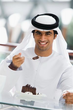 A Middle Eastern man enjoying a meal in a restaurant Photographie de stock - Aubaine LD & Abonnement, Code: 400-04038267