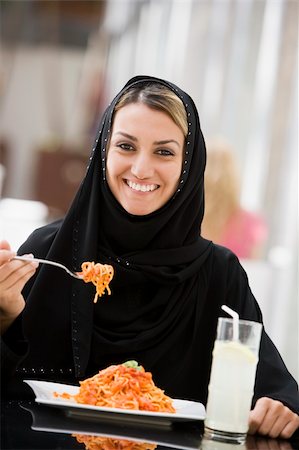A Middle Eastern woman enjoying a meal in a restaurant Photographie de stock - Aubaine LD & Abonnement, Code: 400-04038268