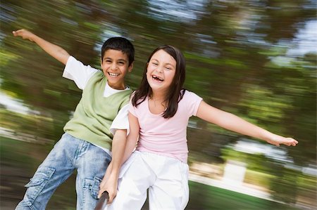 Two children having fun on spinning roundabout in playground Foto de stock - Super Valor sin royalties y Suscripción, Código: 400-04038279
