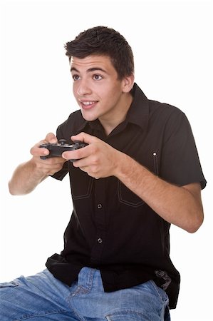 Handsome young man, playing a computer / console game. Isolated on white. Studio Shot. Stock Photo - Budget Royalty-Free & Subscription, Code: 400-04038939