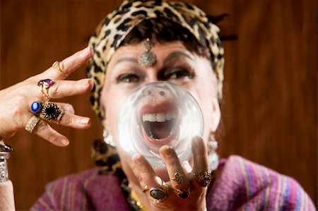 Female gypsy fortune teller holding a crystal ball to her eye Stock Photo - Budget Royalty-Free & Subscription, Code: 400-04038959