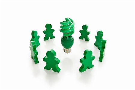 Circle of green wooden people surrounding a bright green compact fluorescent light bulb. Isolated on white. Foto de stock - Royalty-Free Super Valor e Assinatura, Número: 400-04039229