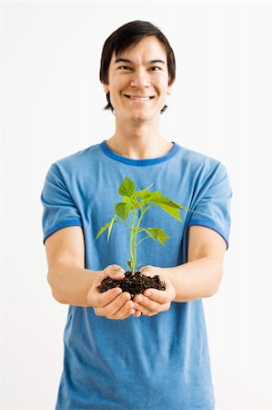 Asian man standing holding growing cayenne plant. Stock Photo - Budget Royalty-Free & Subscription, Code: 400-04039885