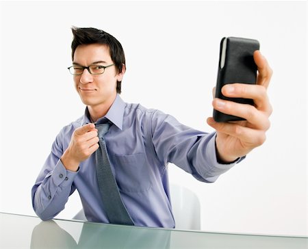 simsearch:400-04639378,k - Businessman taking photograph of himself using pda or mobile phone deivice. Stock Photo - Budget Royalty-Free & Subscription, Code: 400-04039913