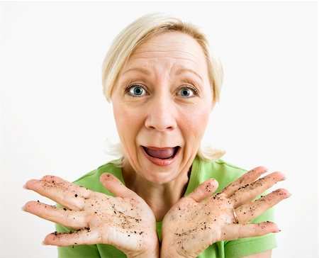 Exasperated adult blonde woman with hands covered in dirt. Stock Photo - Budget Royalty-Free & Subscription, Code: 400-04039971