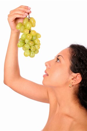 simsearch:693-06021794,k - A woman looks on the bunch of grapes in her hands, standing on white background. Stock Photo - Budget Royalty-Free & Subscription, Code: 400-04030215