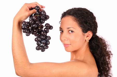 photo of model woman with grapes - A smiling woman holds a bunch of dark grape in her hand, standing on white background. Stock Photo - Budget Royalty-Free & Subscription, Code: 400-04030219