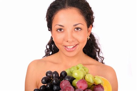 photo of model woman with grapes - A smiling woman holds a plate with different kinds of fruits in her hands, standing on white background. Stock Photo - Budget Royalty-Free & Subscription, Code: 400-04030213