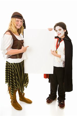 Brother and sister in Halloween costumes holding a blank white sign.  Full body design element, isolated on white. Stock Photo - Budget Royalty-Free & Subscription, Code: 400-04031214