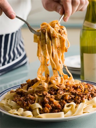 pancetta - Man serving Tagaliatelle with Ragu Sauce Stock Photo - Budget Royalty-Free & Subscription, Code: 400-04031402