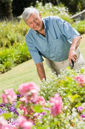 Senior man working in garden using trowel Stock Photo - Budget Royalty-Free & Subscription, Code: 400-04031423