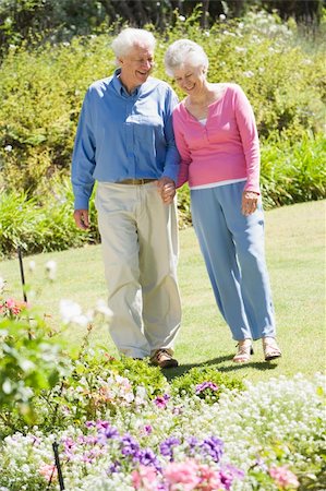 simsearch:400-05314664,k - Senior couple walking in garden admiring flowerbeds Stock Photo - Budget Royalty-Free & Subscription, Code: 400-04031437