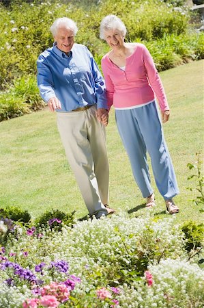 simsearch:400-05314664,k - Senior couple walking in garden admiring flowerbeds Stock Photo - Budget Royalty-Free & Subscription, Code: 400-04031438