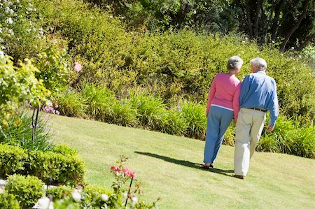 simsearch:400-04890264,k - Senior couple walking in garden holding hands Stock Photo - Budget Royalty-Free & Subscription, Code: 400-04031439
