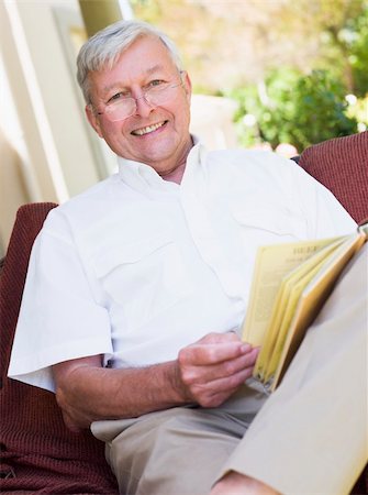 Senior man relaxing with book sitting on garden seat Stock Photo - Budget Royalty-Free & Subscription, Code: 400-04031459