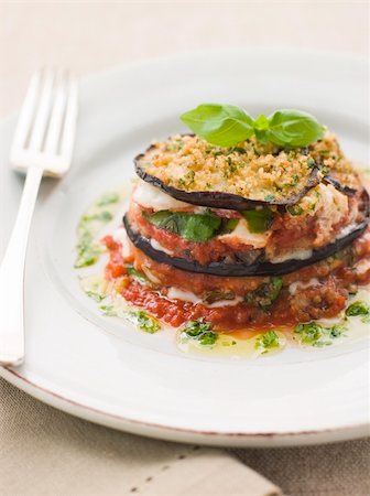 eggplant parmesan - Plate of Aubergine Parmigiana Tower with Herb Oil Stock Photo - Budget Royalty-Free & Subscription, Code: 400-04031482