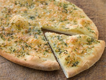 pane all'aglio - Close up of Garlic Pizza Bread Fotografie stock - Microstock e Abbonamento, Codice: 400-04031555