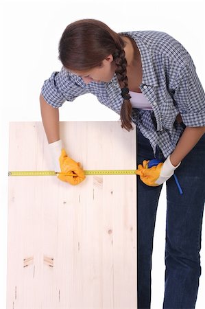 female builders carpentry - woman carpenter with wooden plank and measuring tape Stock Photo - Budget Royalty-Free & Subscription, Code: 400-04032104