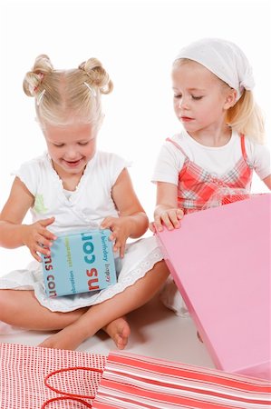 two cute girls celebrating special occasion, unpacking gifts together Photographie de stock - Aubaine LD & Abonnement, Code: 400-04032115