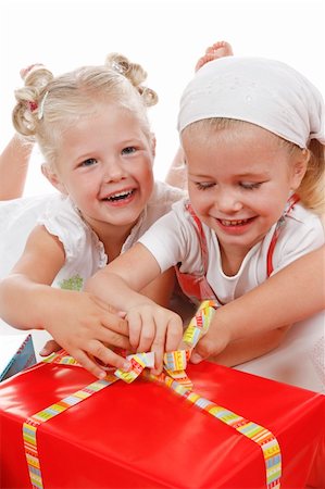 two cute girls celebrating special occasion, unpacking gifts together Photographie de stock - Aubaine LD & Abonnement, Code: 400-04032119