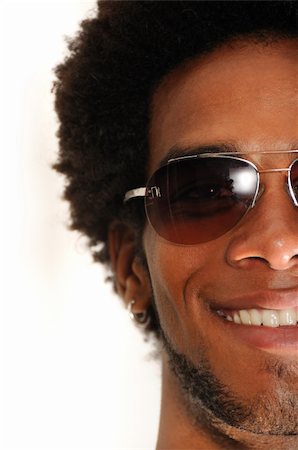 Portrait of young happy latino male wearing sunglasses Stock Photo - Budget Royalty-Free & Subscription, Code: 400-04032152