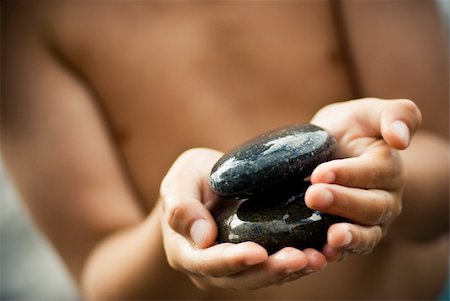 child holding pebble in his hand Stock Photo - Budget Royalty-Free & Subscription, Code: 400-04032727