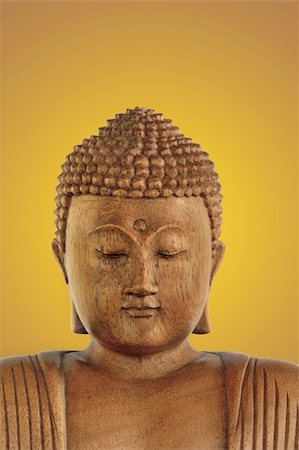 simsearch:400-05099216,k - Wooden Buddha with eyes closed in prayer over a glowing golden background. Stock Photo - Budget Royalty-Free & Subscription, Code: 400-04033050