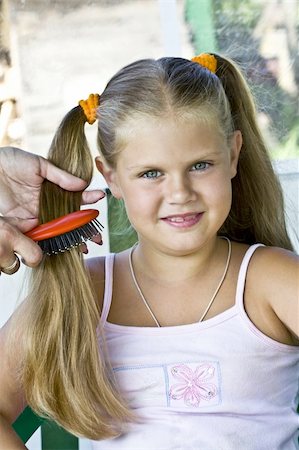 Little blond long hair girl has haircare by stylist. Stock Photo - Budget Royalty-Free & Subscription, Code: 400-04033067