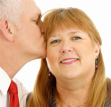 simsearch:400-05234340,k - Closeup of a beautiful plus sized woman getting a kiss from a handsome guy.  White background. Stock Photo - Budget Royalty-Free & Subscription, Code: 400-04033107