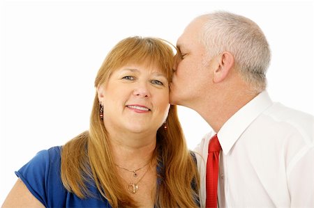 simsearch:400-05234340,k - Beautiful mature woman receiving a kiss on the cheek from her husband.  Isolated on white. Stock Photo - Budget Royalty-Free & Subscription, Code: 400-04033110