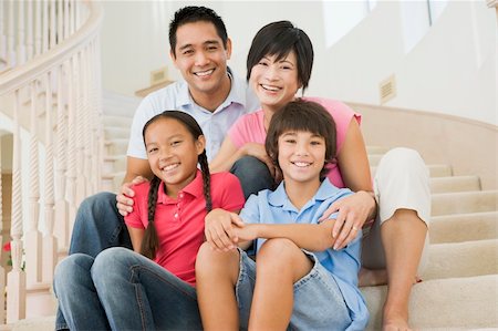 Family sitting on staircase smiling Stock Photo - Budget Royalty-Free & Subscription, Code: 400-04044008