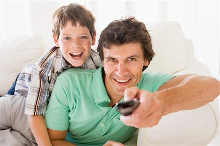 simsearch:400-04045202,k - Man and young boy with remote control smiling Stock Photo - Budget Royalty-Free & Subscription, Code: 400-04044039