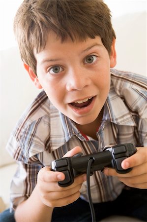 simsearch:400-04199147,k - Young boy holding video game controller Photographie de stock - Aubaine LD & Abonnement, Code: 400-04044032