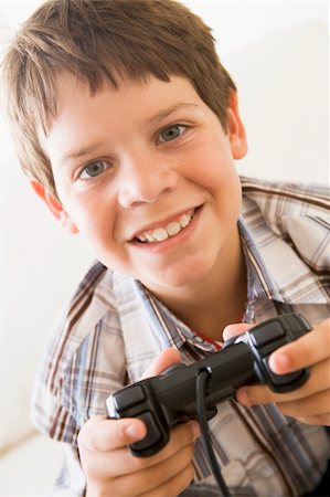 simsearch:400-04200279,k - Young boy holding video game controller smiling Stock Photo - Budget Royalty-Free & Subscription, Code: 400-04044033