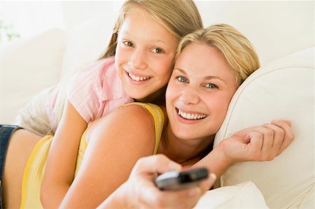 simsearch:400-04045202,k - Woman and young girl with remote control embracing on sofa smili Stock Photo - Budget Royalty-Free & Subscription, Code: 400-04044040