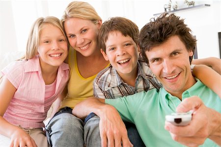 simsearch:400-04046300,k - Family in living room with remote control smiling Stock Photo - Budget Royalty-Free & Subscription, Code: 400-04044042