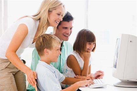 simsearch:400-04044108,k - Family in home office using computer smiling Stock Photo - Budget Royalty-Free & Subscription, Code: 400-04044064